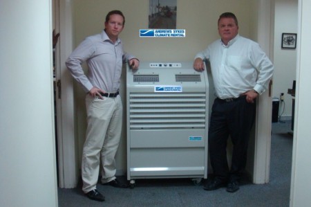 High quality temporary air conditioning hire from Andrews Sykes Climate Rental Middle East LLC (GM - Clinton Wyngard together with Dave Crawford – Khansaheb Sykes GM standing next to a PAC22 - one of the high capacity portable air conditioning units within the rental fleet.
